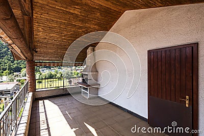 Terrace with wooden ceiling and tiles, landscape and hills Stock Photo