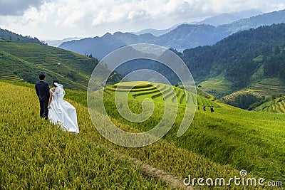 Terraced rice field in Mu Cang Chai, Vietnam, with happy travel couple Editorial Stock Photo