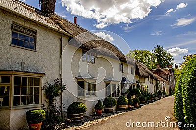 Terraced thatched cottages in the village of Avebury, Wiltshire in the UK. Stock Photo