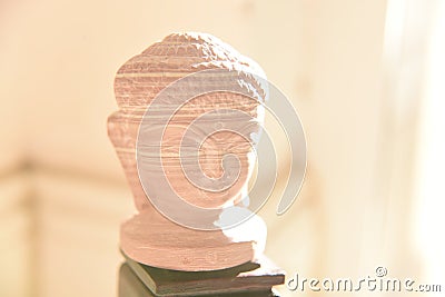 Terracotta Buddha head statue on a standing post Stock Photo