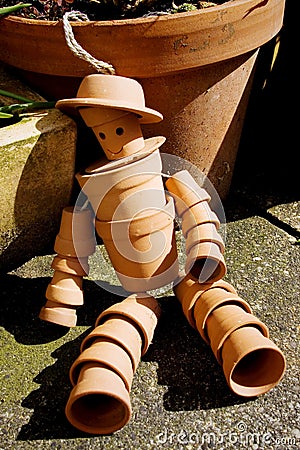 Terracotta flower pot man Stock Photo