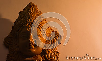 terracotta sculpture of face of goddess Durga for Durga Puja festival in west bengal india. shot against white background in Stock Photo