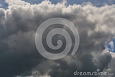 A terrible black cloud hangs in the sky before the rain. Bad weather. Hurricane and thunder over the city. Climate change and Stock Photo