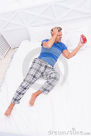 Terrible noise. Insomnia and sleep disorder. Daily routine. What day is today. Stressful man wake up turn off alarm Stock Photo