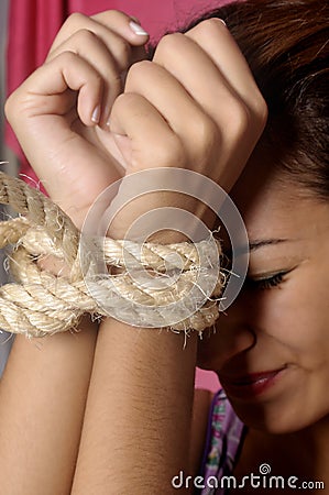 Terrified female prisoner Stock Photo