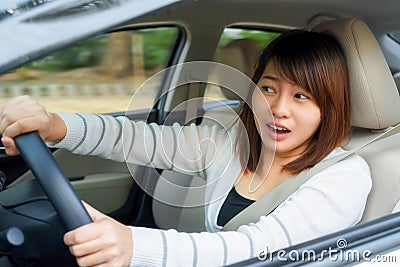 Terrified woman driving and having car accident or crash something. Stock Photo