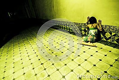 Terrified woman on wall Stock Photo