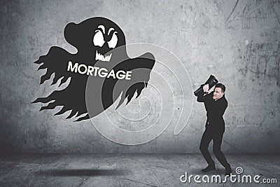 Terrifying businessman covering his face chased by a debt collector Stock Photo