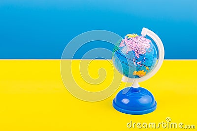 Territory of Russia on the map, globe Ukrainian flag background blue and yellow. Stop war. Stock Photo