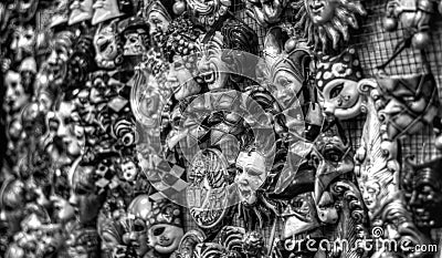 the masks hanging on a wall in black and white Stock Photo