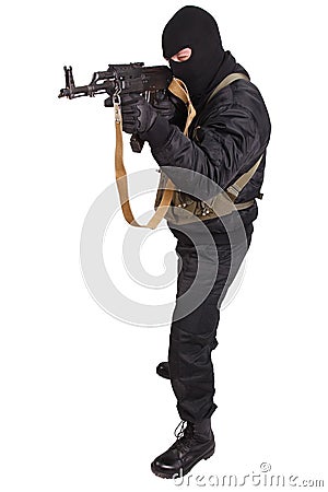 Terrorist in black uniform and mask with kalashnikov Stock Photo