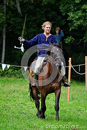 TERVETE, LATVIA - AUGUST 13, 2011: Historical Zemgalu days. Unknown rider on horseback in ancient clothing with ancient weapons Editorial Stock Photo