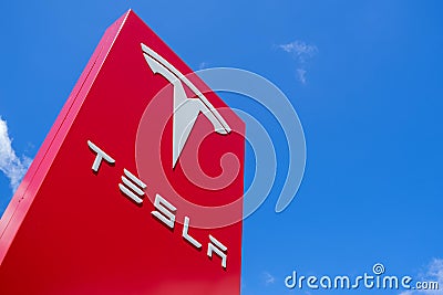 Tesla dealership sign against blue sky Editorial Stock Photo