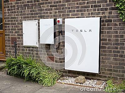 Tesla Powerwall 2 and Backup Gateway 2 on a house wall Editorial Stock Photo