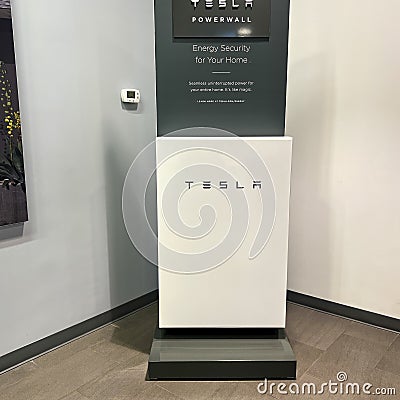 The Tesla Powerwall and Sign at the entrance of the Tesla dealership in Orlando, FL Editorial Stock Photo