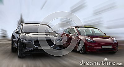 Tesla is a red car and Jaguar is a black car. Stock Photo