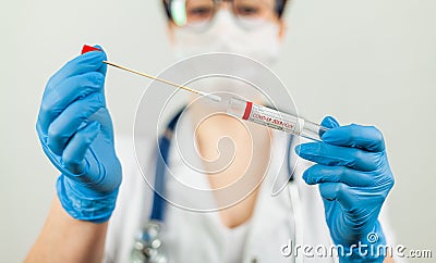 Test for coronavirus Covid-19. Female doctor or nurse doing lab analysis of a nasal swab in a hospital laboratory. Stock Photo