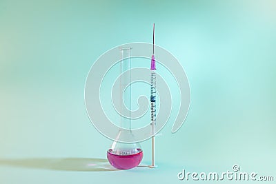 A test tube and a syringe isolated. Science and cure concept Stock Photo