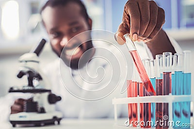 Skillful chemist placing test tubes in order Stock Photo