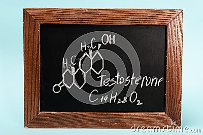 Of testosterone on blackboard on blue Stock Photo
