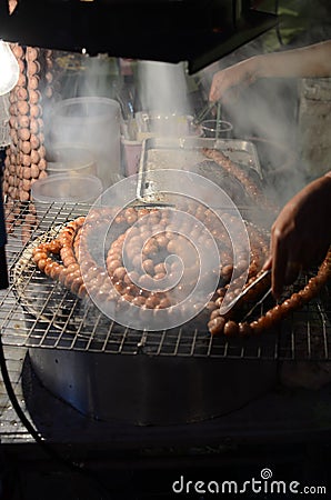 A testy Thai sausage grilling on stove Stock Photo