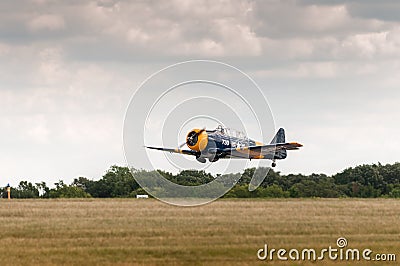 AT-6 Texan Flies Low Over Runway Editorial Stock Photo