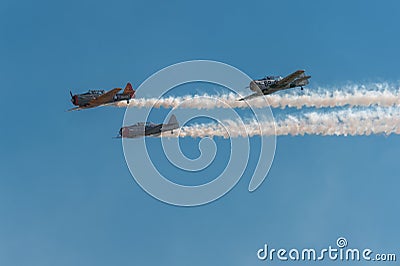 AT-6 Texan Trio With Smoke and Blue Sky Editorial Stock Photo