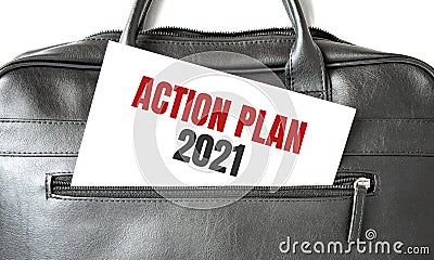 Text ACTION PLAN 2021 writing on white paper sheet in the black business bag. Business concept Stock Photo