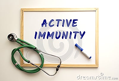 The text ACTIVE IMMUNITY is written on a white office board. Nearby is a stethoscope Stock Photo