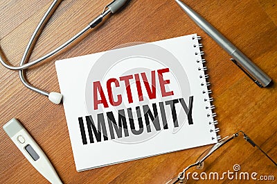 The text ACTIVE IMMUNITY is written on a white sheet Stock Photo