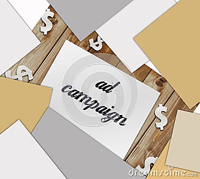 Text Ad Campaign on text, paper signs of dollar on wood table. Business concept Stock Photo