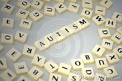 text autism on the gray background near the letters. Stock Photo