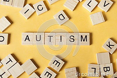 Text AUTISM on wood cubes. Wooden abc Stock Photo