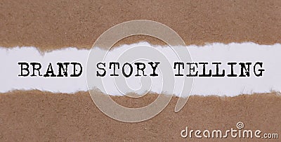 Text BRAND STORY TRLLING appearing behind ripped brown paper Stock Photo