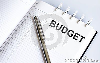 Text BUDGET on the short note texture background with pen Stock Photo