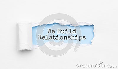 The text We Build Relationships appearing behind torn yellow paper Stock Photo