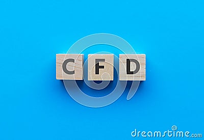 Text CFD on wooden cubes on bright blue background. Abbreviation from Contract for difference. Business Stock Photo