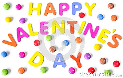 Text of colorful letters Happy Valentines day among multicolored round sweets. Isolated Stock Photo