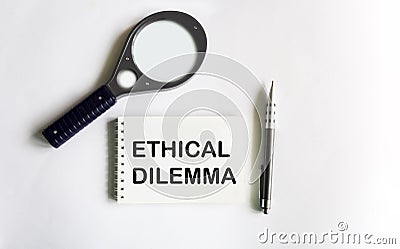 Text Ethical Dilemma on notepad, magnifier and pen, business concept Stock Photo