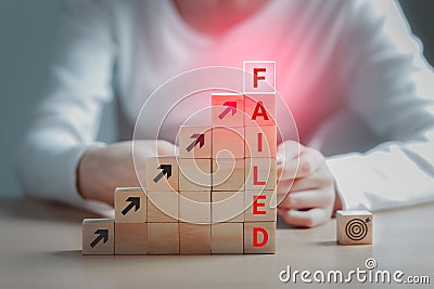 Text failed on the wooden block and the dartboard icon is on the floor, Failing ideas metaphor, Concept for challenge and fail in Stock Photo