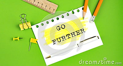 Text GO FURTHER sign showing on green background with office tools Stock Photo