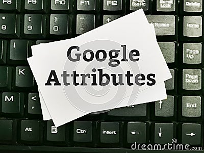 Text GOOGLE ATTRIBUTES written on white paper note on computer keyboard. Editorial Stock Photo