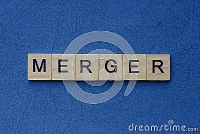 text on gray word merger in small wooden letters Stock Photo