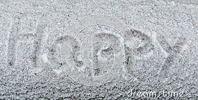 Text Happy in the white snow. Handwriting the word Happy in the snow. Snow background texture and cold winter concept Stock Photo