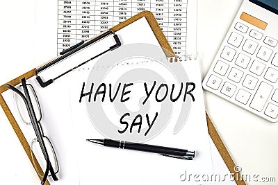 Text HAVE YOUR SAY on the white paper on clipboard with chart and calculator Stock Photo