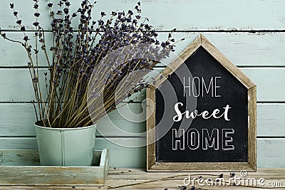 Text home sweet home in a house-shaped signboard Stock Photo