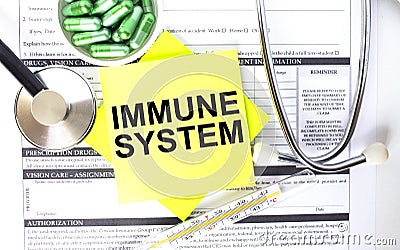 Text Immune System in a notebook on medical forms with a phonendoscope and green pills Stock Photo