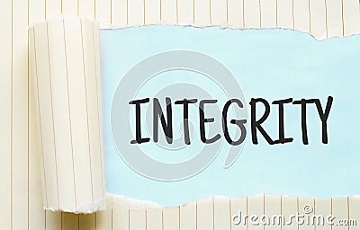 The text INTEGRITY appearing behind torn white paper Stock Photo