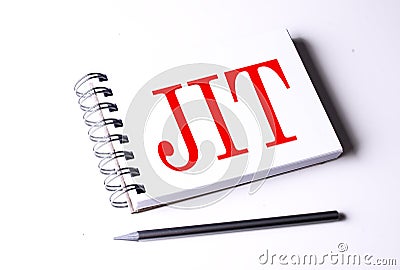 Text JIT on notebook on the white background, business Stock Photo