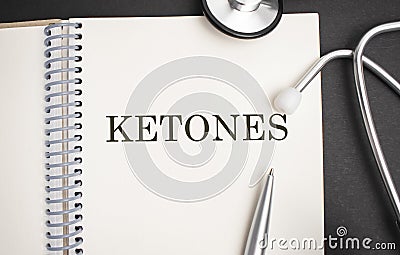 Text KETONES on a white background with stethoscope. Medical concept Stock Photo